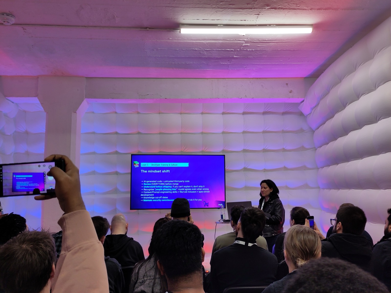 Snyk talk slide on the mindset shift needed for AI-generated code: review everything, understand before shipping